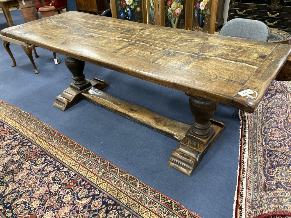 An oak refectory table on turned end supports, width 222cm depth 84cm height 77cm